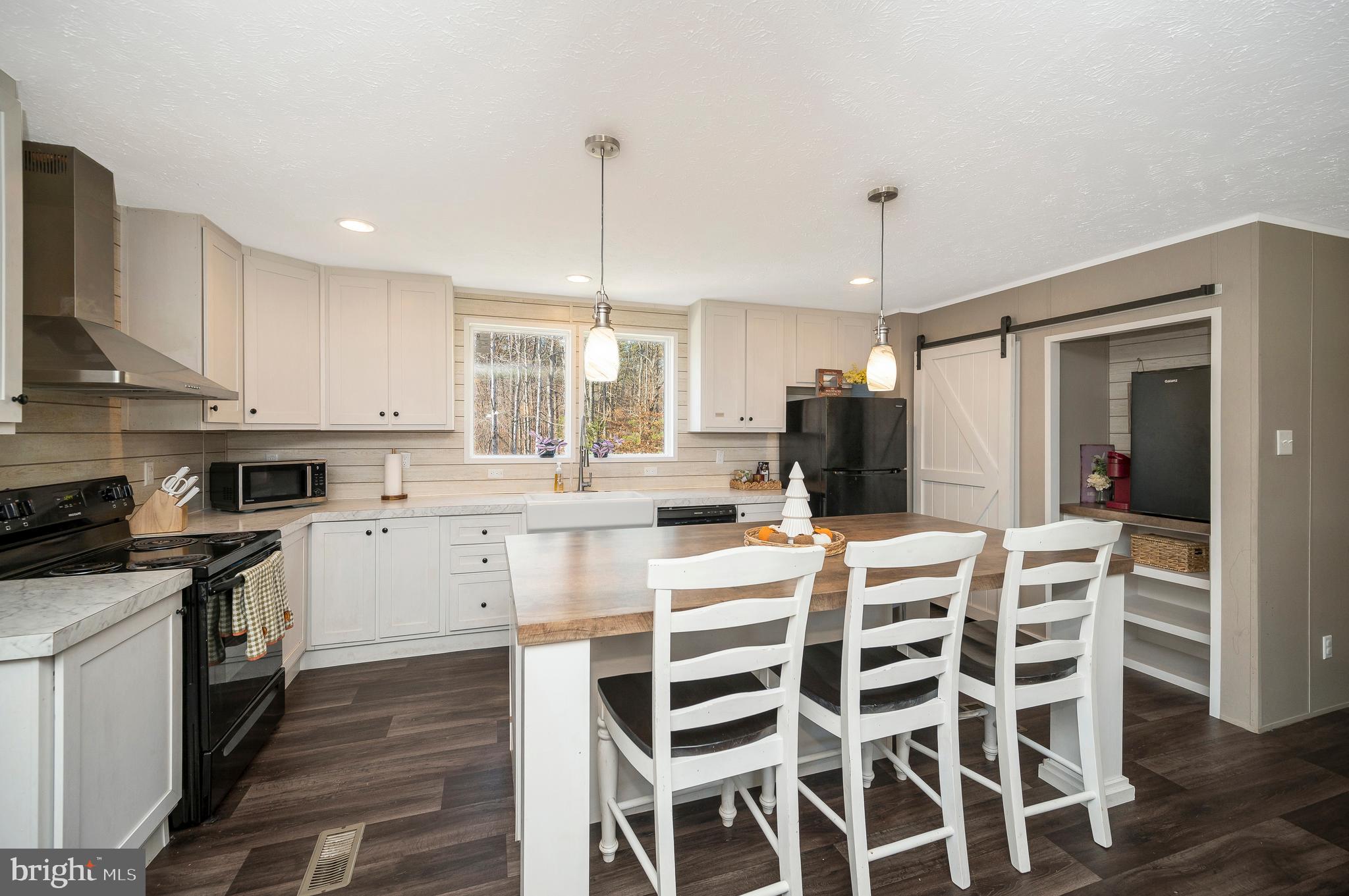 5120 Burr Hill Road Rhoadesville, VA 22542 - Photo 10 of 45 a kitchen with stainless steel appliances kitchen island granite countertop a table and chairs in it