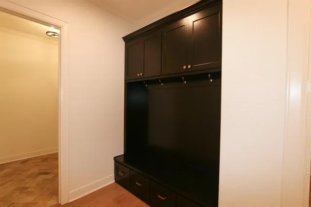 a view of a livingroom with a window and wooden floor