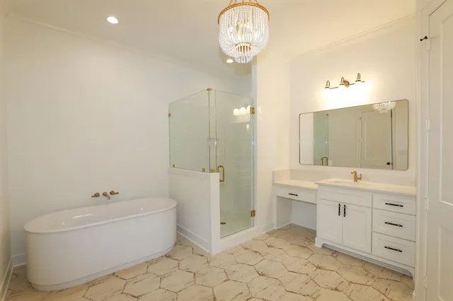 an empty room with wooden floor chandelier fan and windows