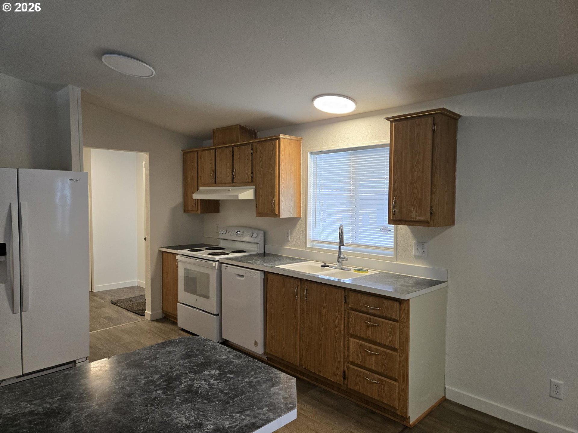 550 South State Street Sutherlin, OR 97479 - Photo 2 of 10 a kitchen with a sink cabinets and stainless steel appliances