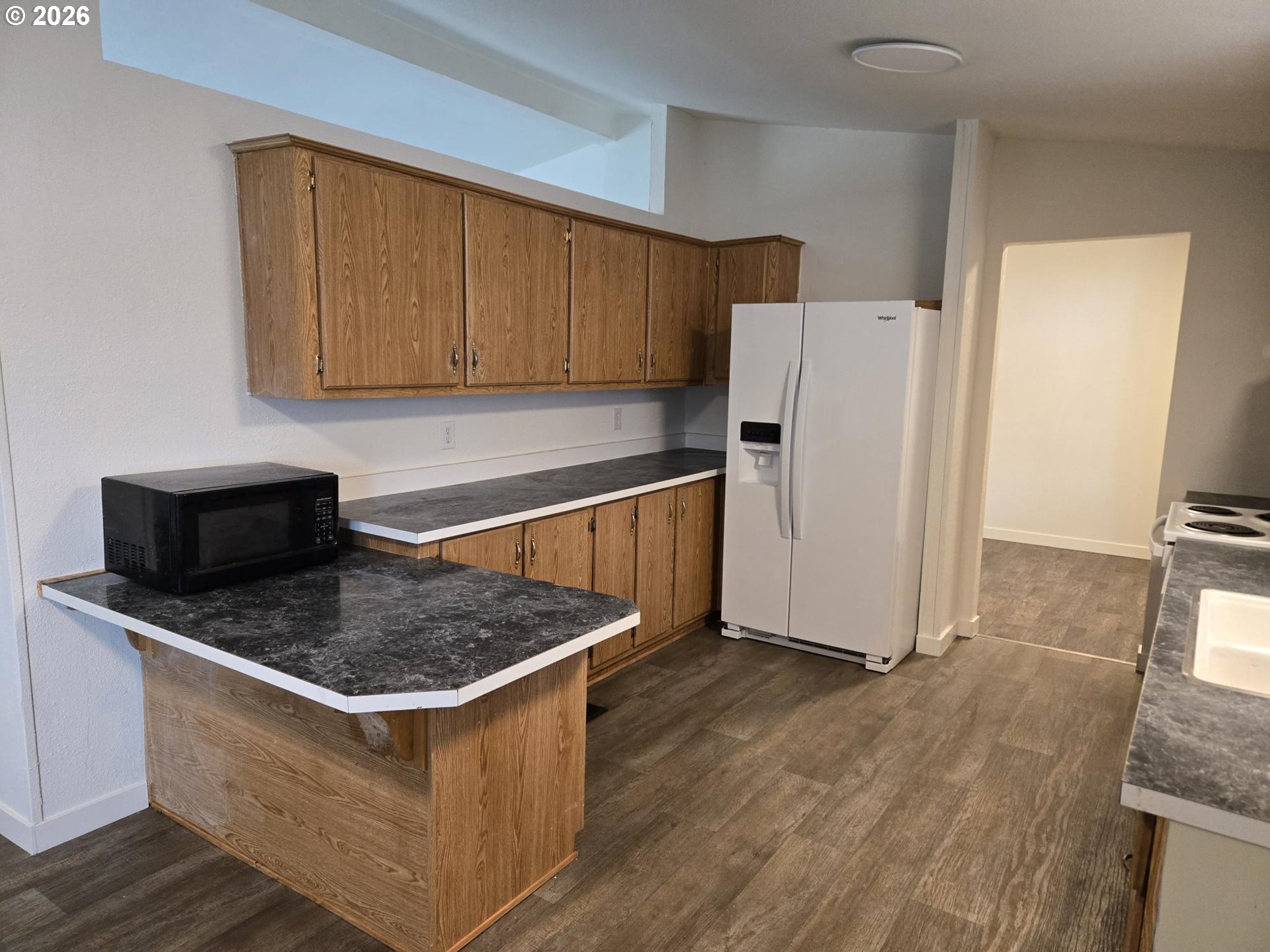 550 South State Street Sutherlin, OR 97479 - Photo 3 of 10 a kitchen with stainless steel appliances granite countertop a refrigerator a sink a stove a microwave and island