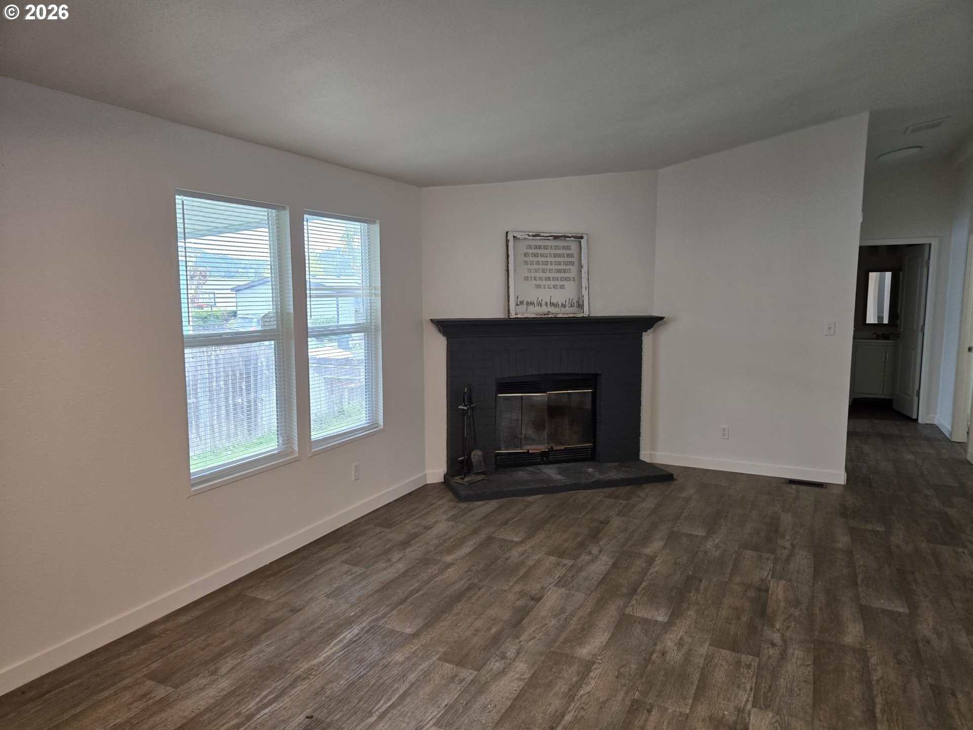 550 South State Street Sutherlin, OR 97479 - Photo 4 of 10 a view of an empty room with wooden floor and a window