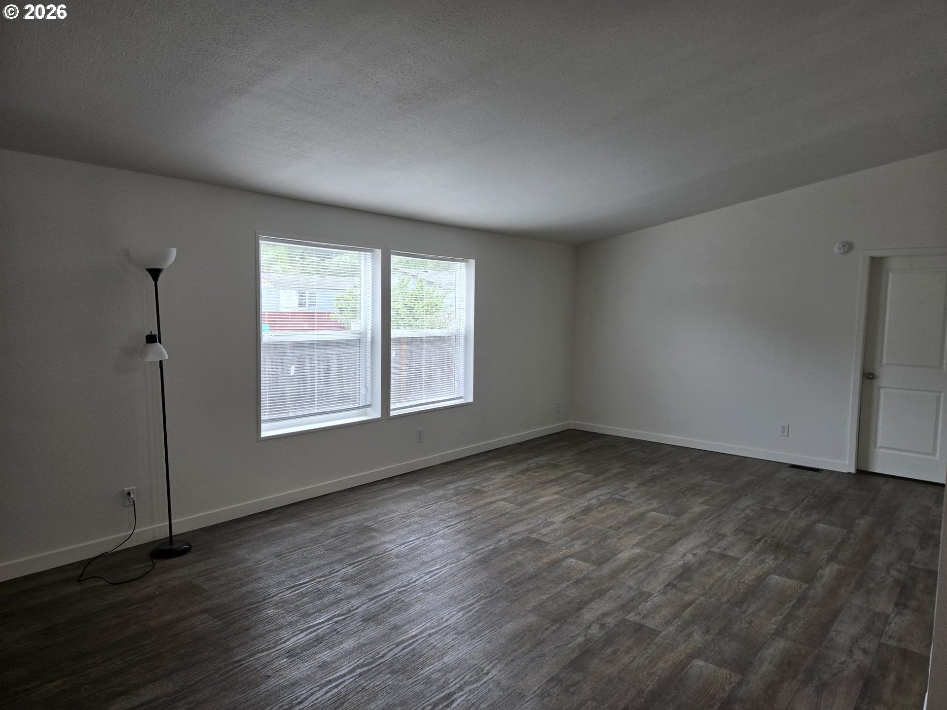 550 South State Street Sutherlin, OR 97479 - Photo 9 of 10 an empty room with wooden floor and windows