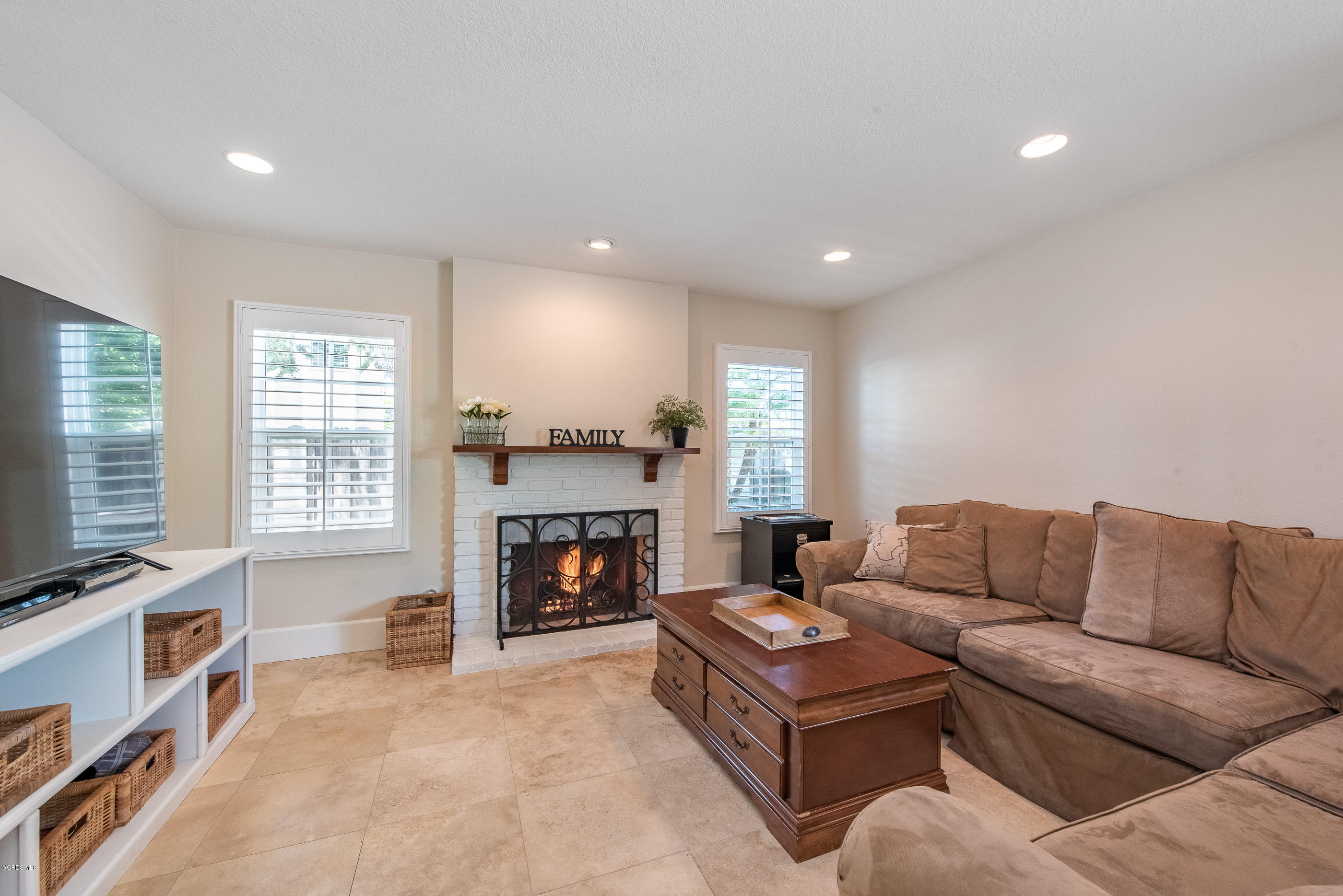 665 Azalea Street Thousand Oaks, CA 91360 - Photo 14 of 52 a living room with furniture flat screen tv and a fireplace