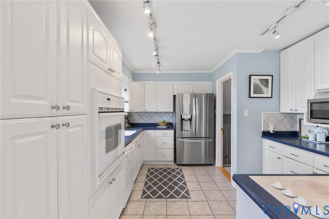 12216 Mt Hermon Road Ashland, VA 23005 - Photo 17 of 49 Kitchen with solid surface countertops, white cabi
