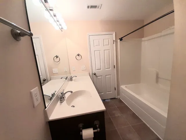 a bathroom with a sink a mirror and a bathtub