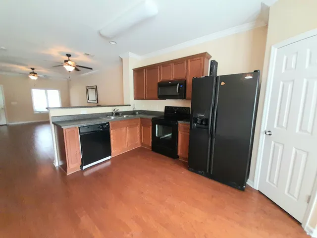 a kitchen with stainless steel appliances granite countertop a stove refrigerator and microwave
