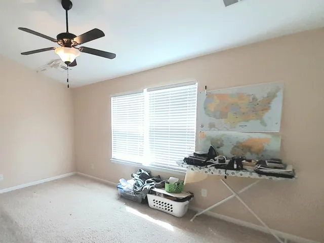 a room with a chandelier furniture and a window