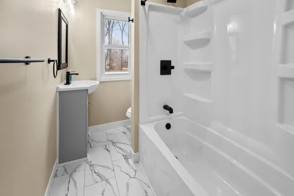 a bathroom with a bathtub sink and toilet