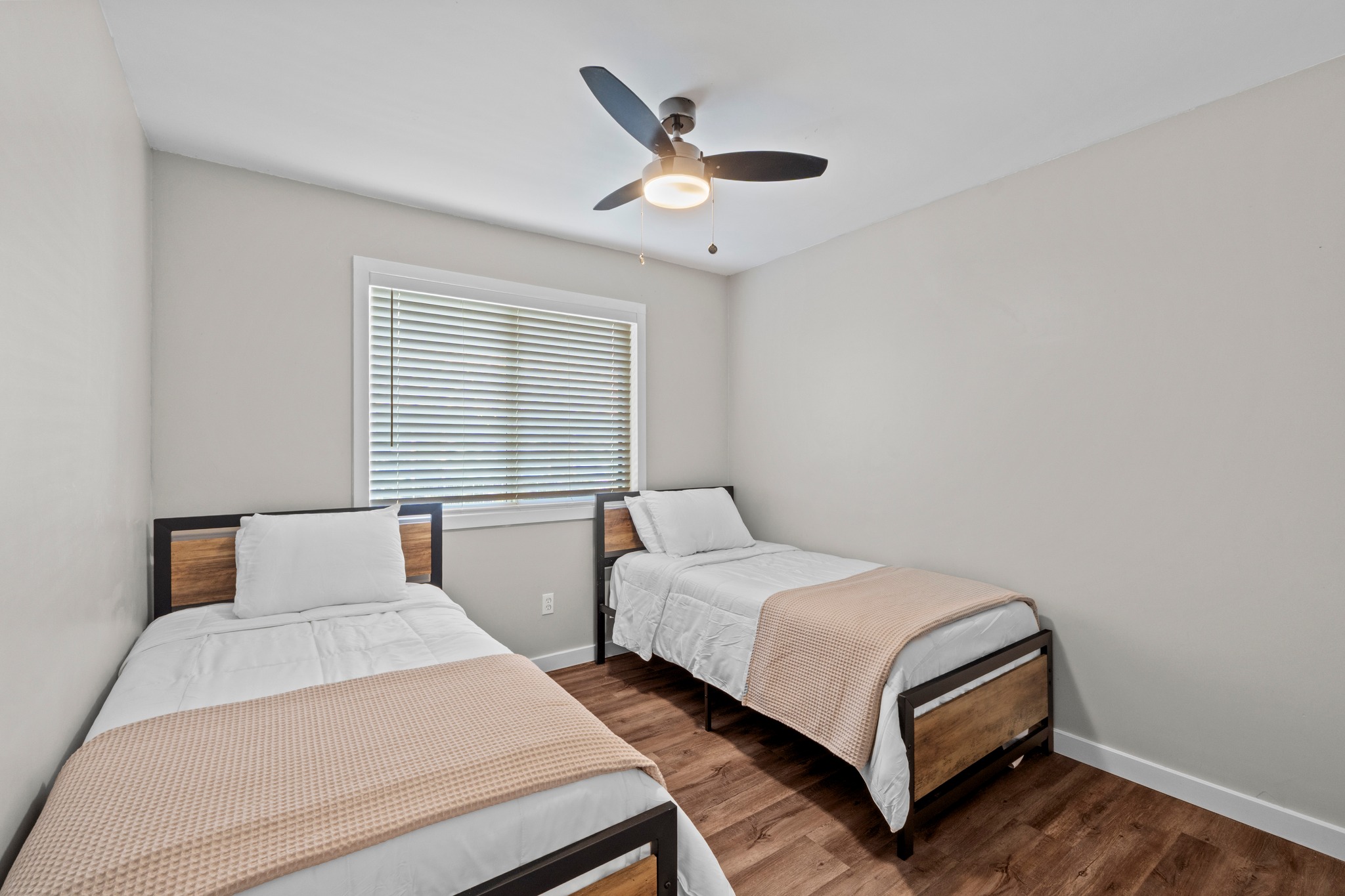 11811 Rotherham Drive Austin, TX 78754 - Photo 25 of 37 Hardwood floors and a bright window elevate this comfortable bedroom.