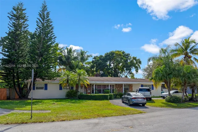 a front view of house with yard and trees