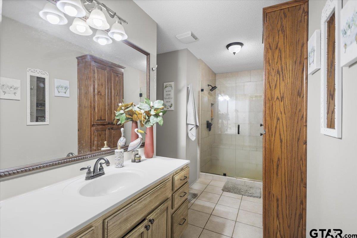 14716 Fox Ridge Tyler, TX 75709 - Photo 15 of 25 a bathroom with a sink vanity and a mirror