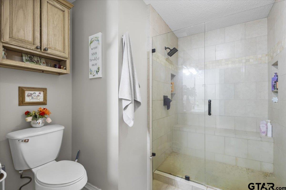 14716 Fox Ridge Tyler, TX 75709 - Photo 16 of 25 a white toilet sitting next to a bath tub shower