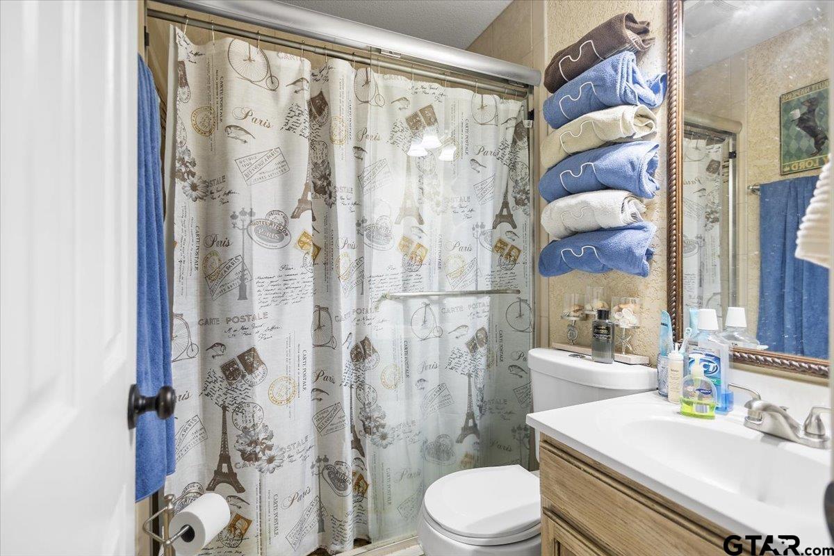 14716 Fox Ridge Tyler, TX 75709 - Photo 19 of 25 a bathroom with a sink a toilet and shower
