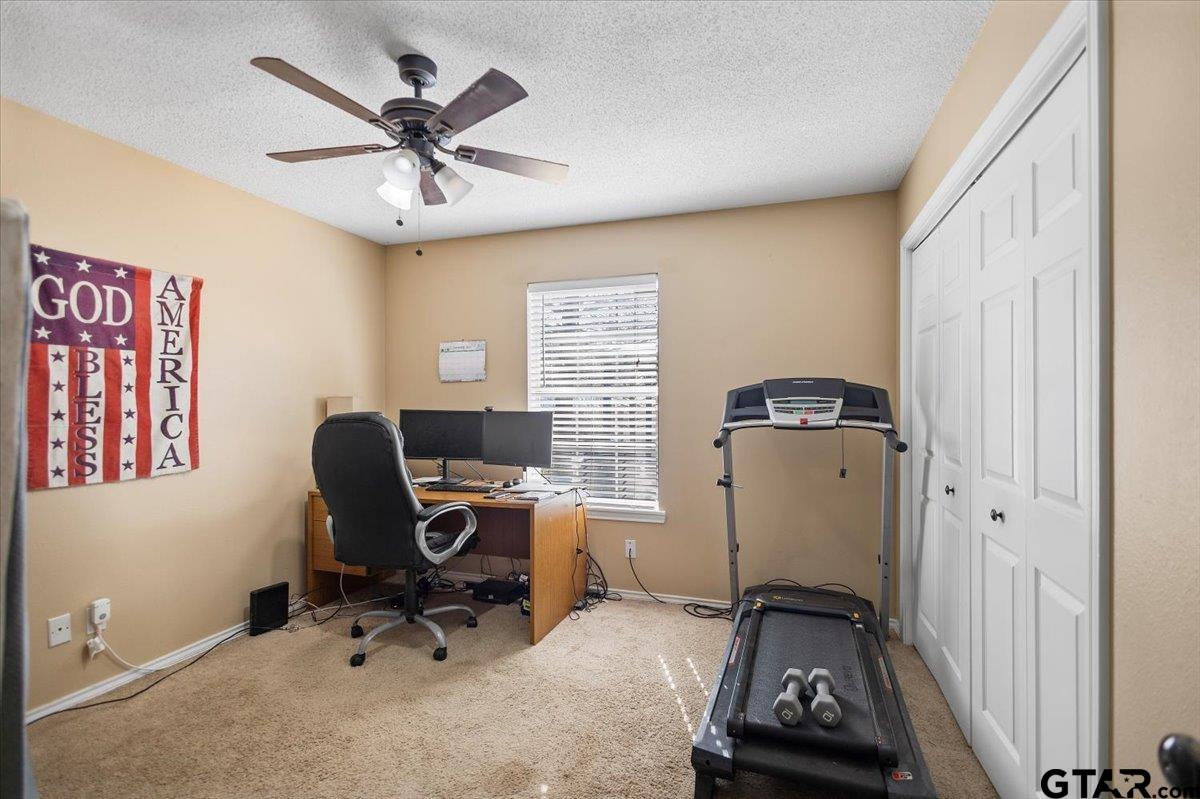 14716 Fox Ridge Tyler, TX 75709 - Photo 20 of 25 a view of workspace with wooden floor windows gym equipment and windows