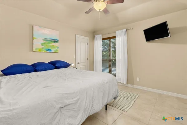 a bedroom with a large bed and a flat screen tv