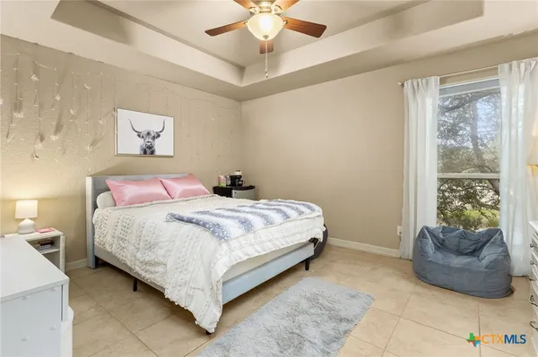 a bedroom with a large bed and a large window
