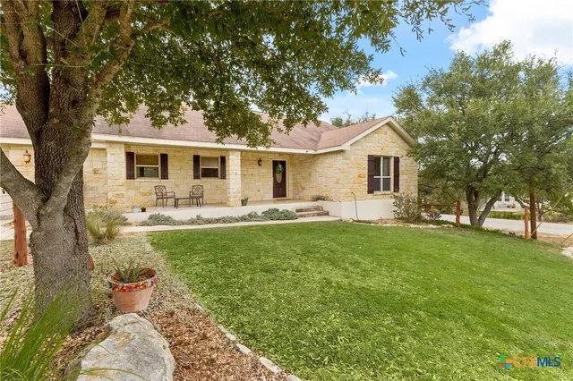 a front view of house with yard and green space