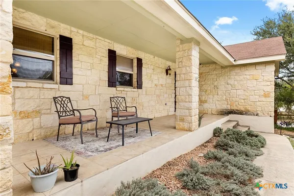 a building outdoor space with patio furniture and potted plants