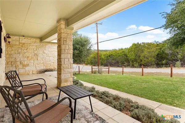 a view of a backyard with a sitting area