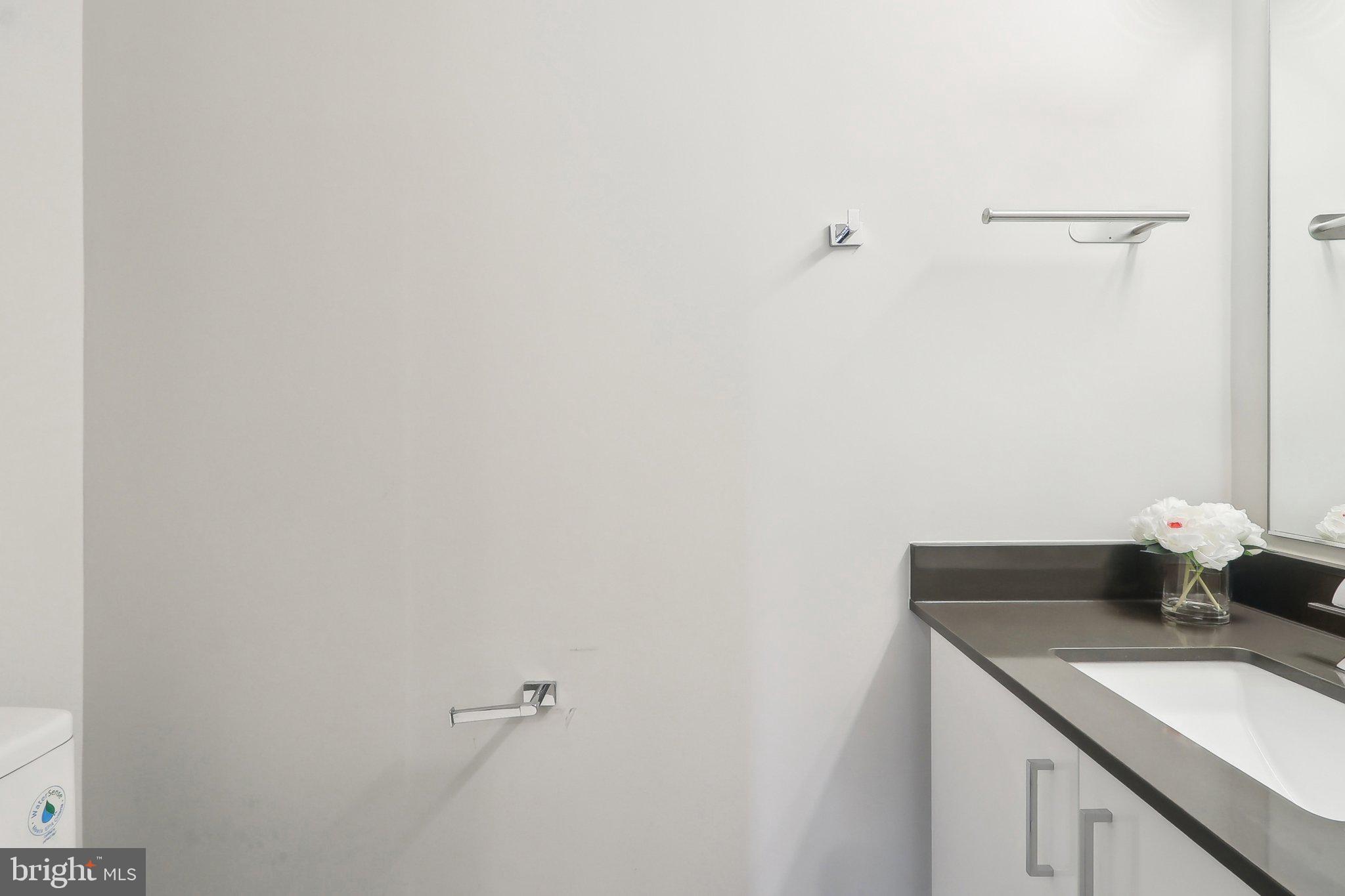 88 V Street Southwest, Unit 311 Washington, DC 20024 - Photo 15 of 32 a bathroom with a granite countertop sink and vanity