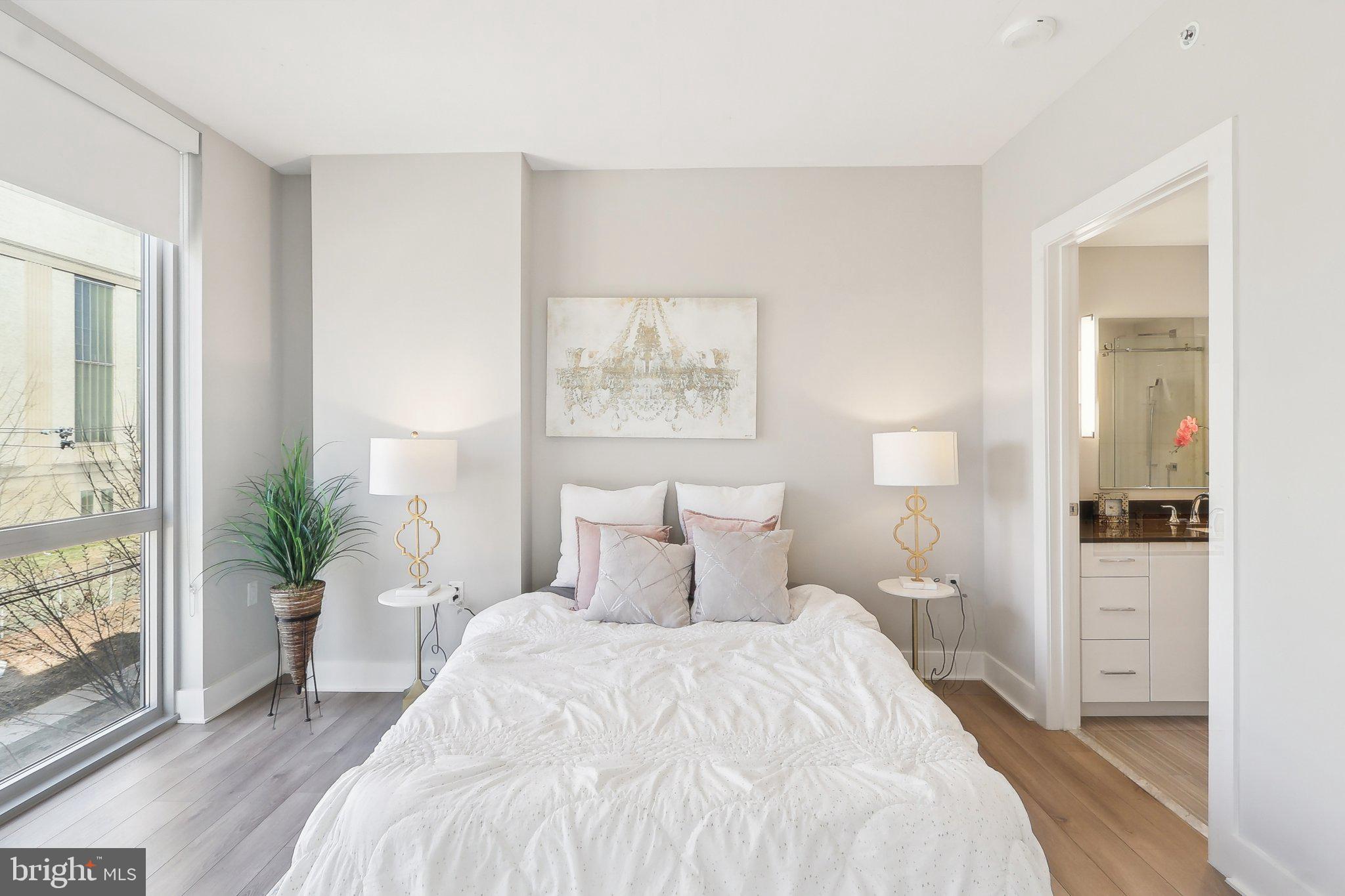 88 V Street Southwest, Unit 311 Washington, DC 20024 - Photo 18 of 32 a bedroom with a bed and a painting on the wall