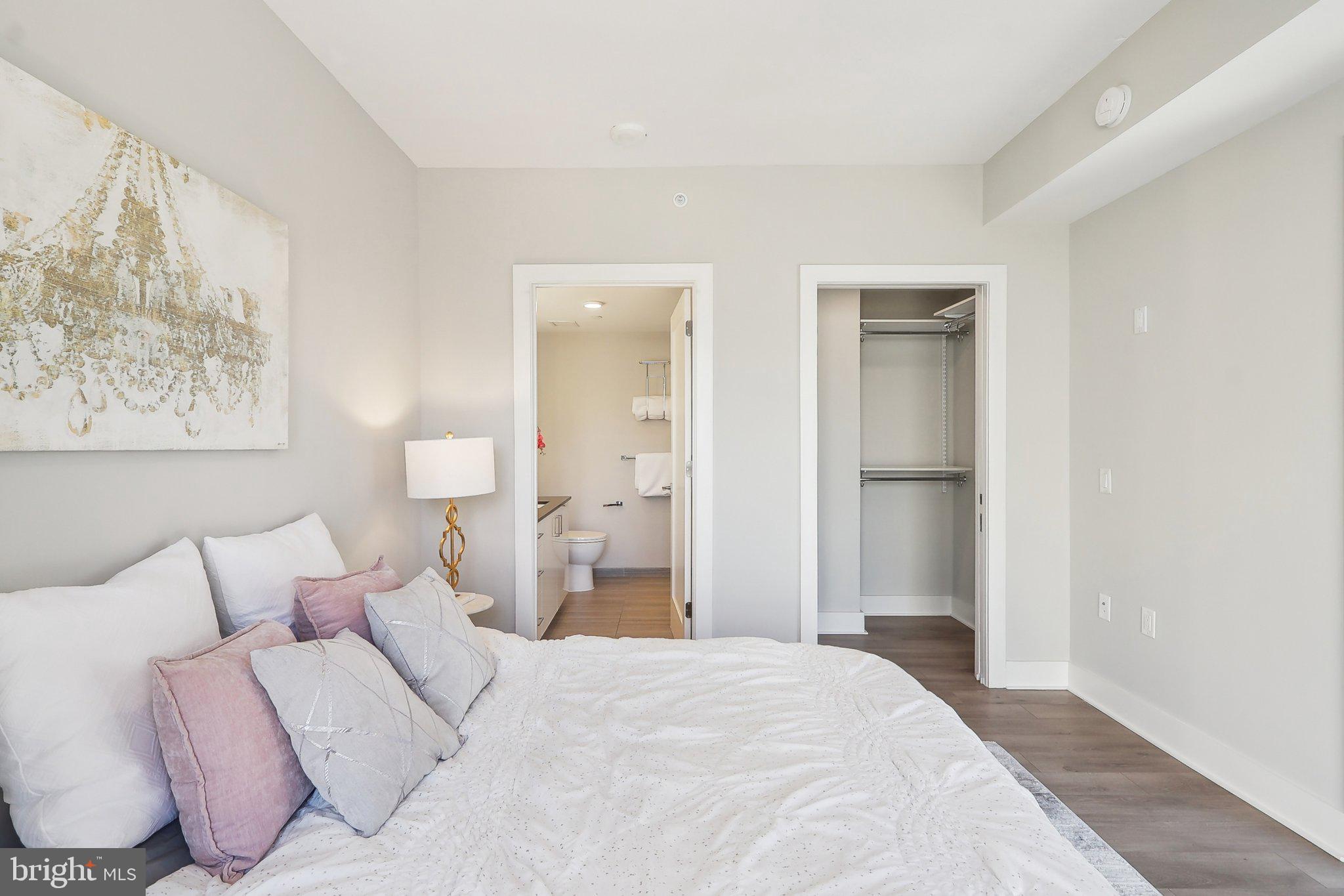 88 V Street Southwest, Unit 311 Washington, DC 20024 - Photo 19 of 32 a bedroom with a bed and a painting on the wall