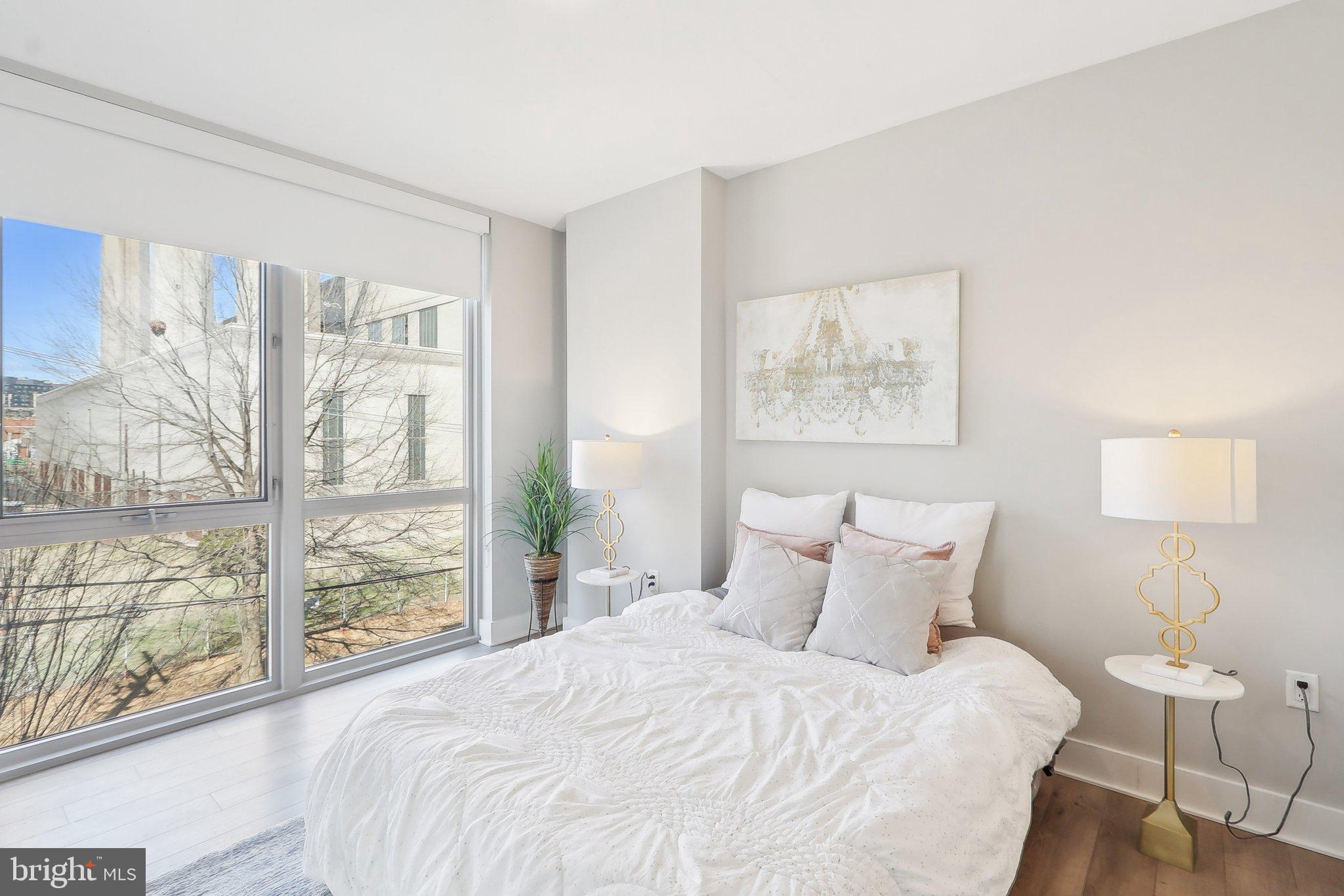 88 V Street Southwest, Unit 311 Washington, DC 20024 - Photo 21 of 32 a bedroom with a large bed and a large window