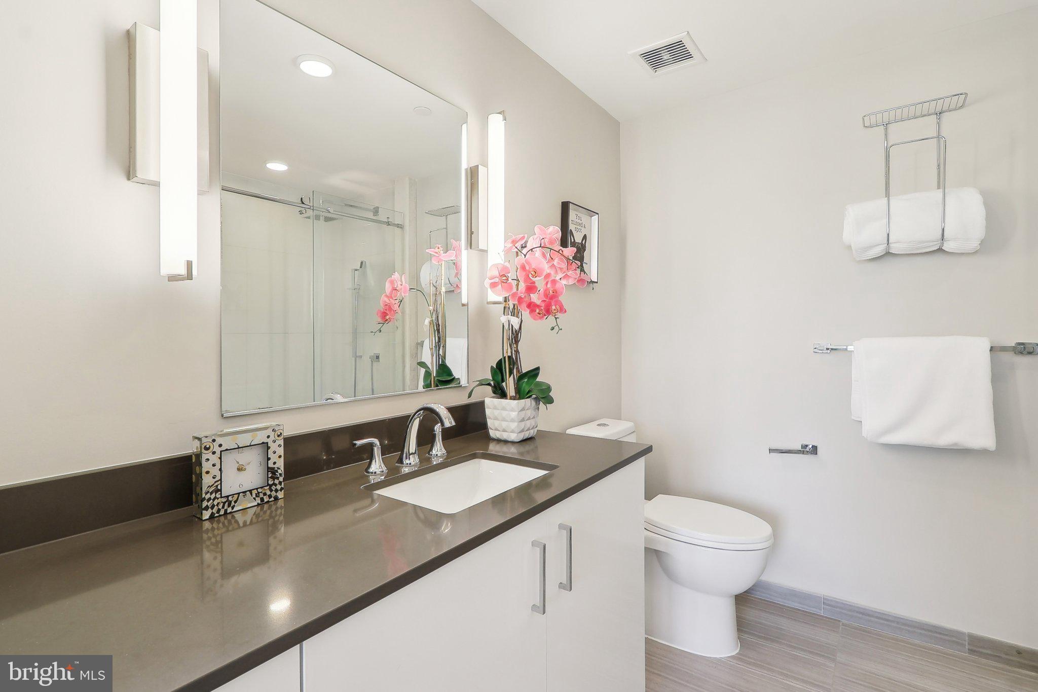88 V Street Southwest, Unit 311 Washington, DC 20024 - Photo 23 of 32 a bathroom with a sink vanity granite and toilet