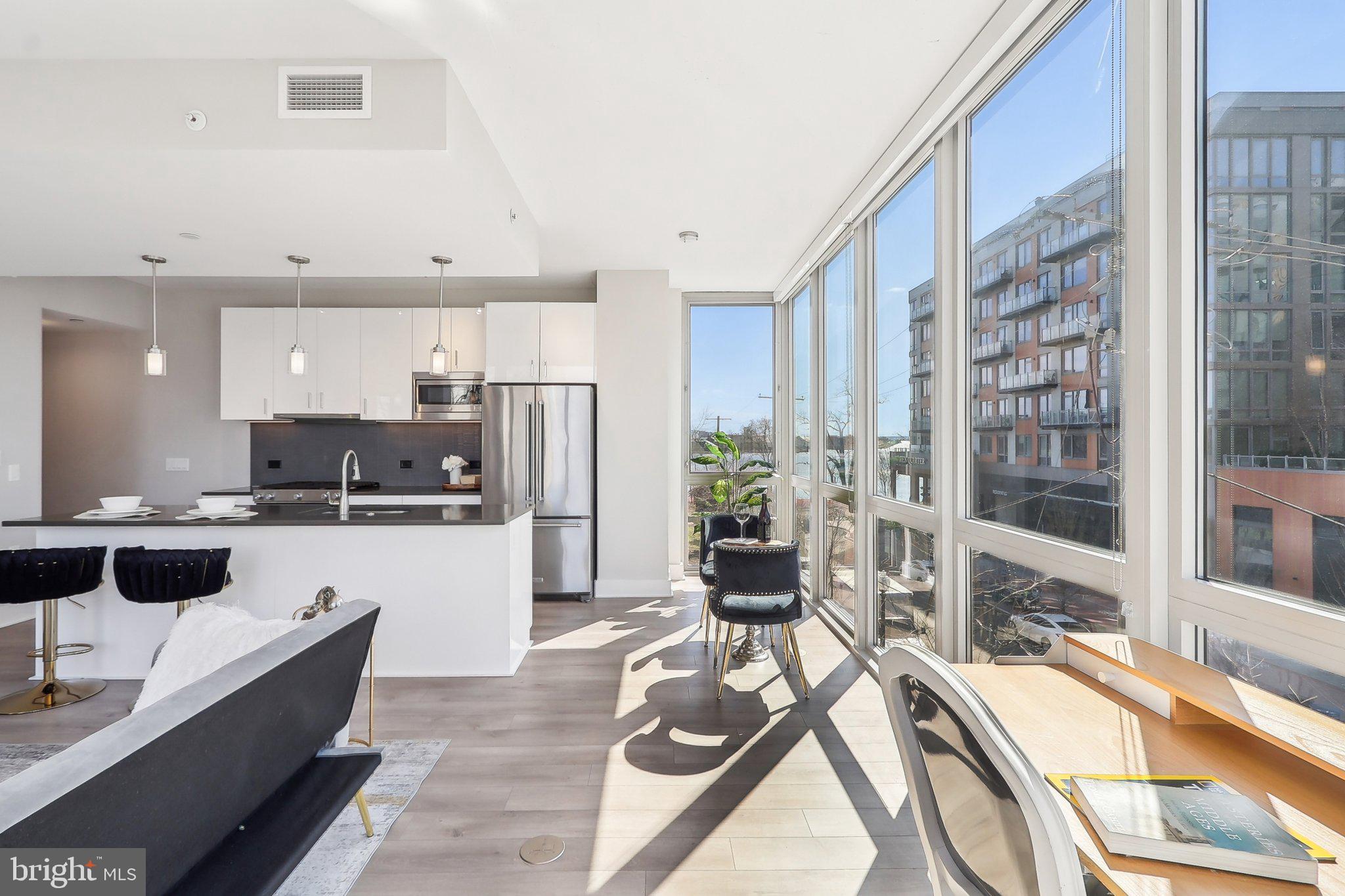 88 V Street Southwest, Unit 311 Washington, DC 20024 - Photo 4 of 32 a large white kitchen with stainless steel appliances kitchen island granite countertop a large counter top stainless steel appliances and cabinets
