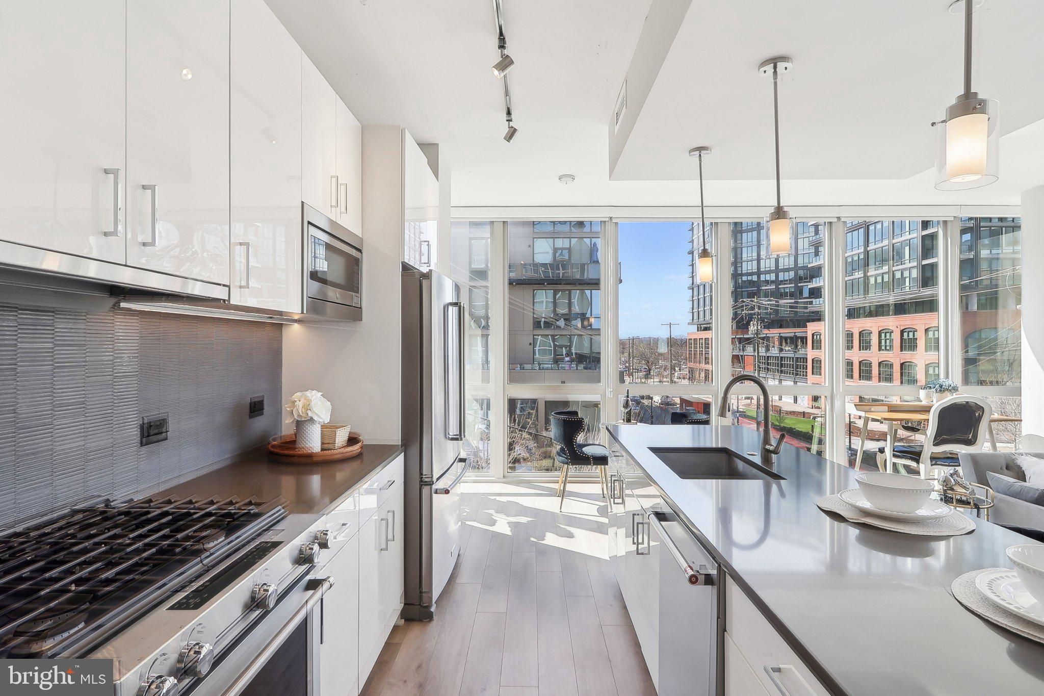 88 V Street Southwest, Unit 311 Washington, DC 20024 - Photo 6 of 32 a kitchen with sink a stove and cabinets