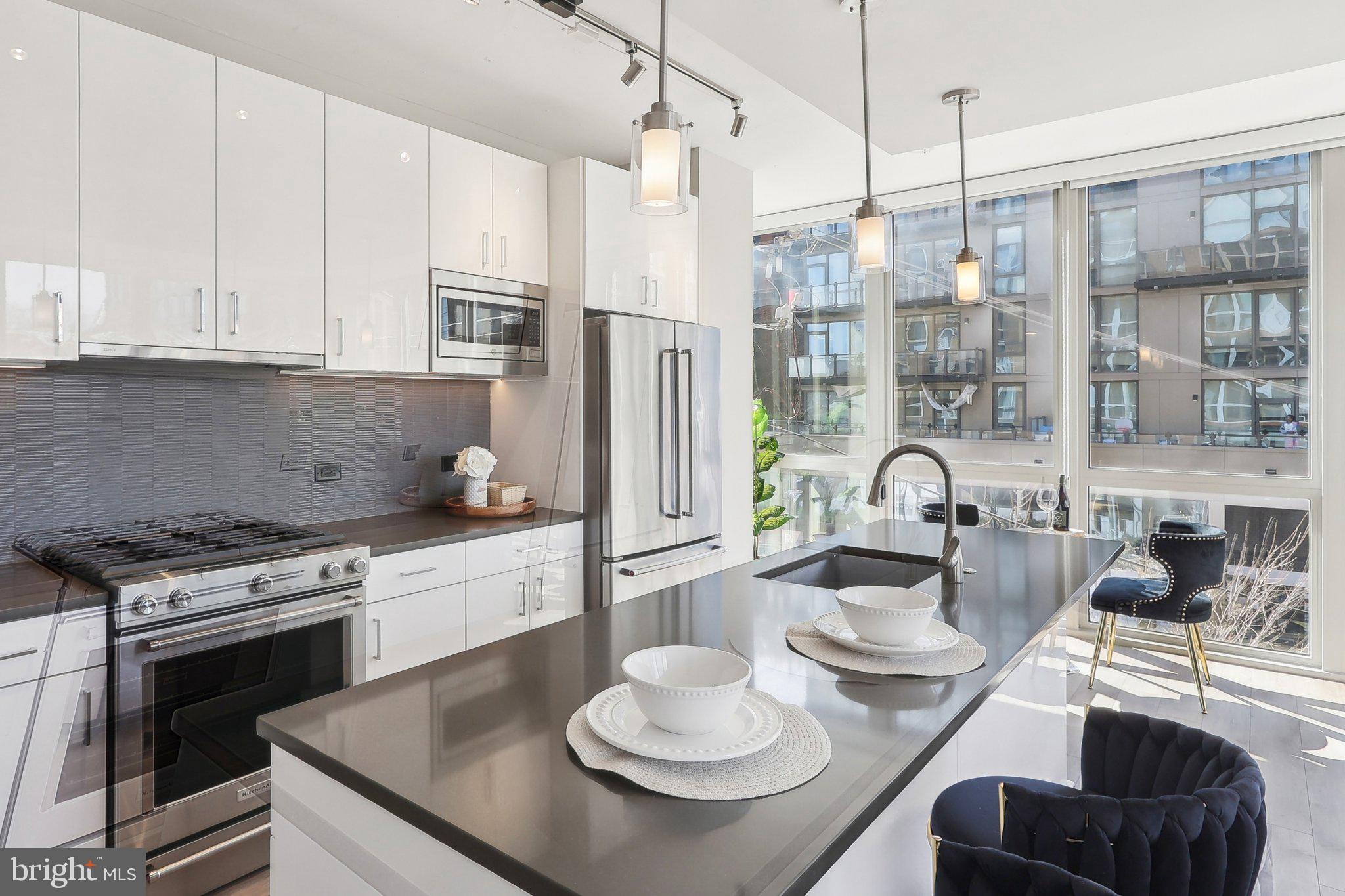 88 V Street Southwest, Unit 311 Washington, DC 20024 - Photo 7 of 32 a kitchen with stainless steel appliances granite countertop a stove a sink and a refrigerator