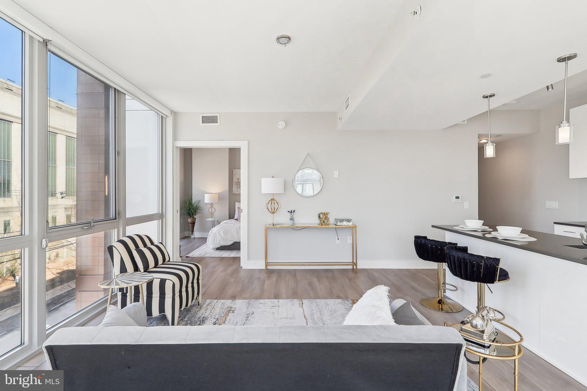 88 V Street Southwest, Unit 311 Washington, DC 20024 - Photo 10 of 32 a living room with furniture and a large window