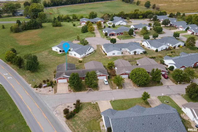 an aerial view of a house with yard swimming pool and outdoor seating