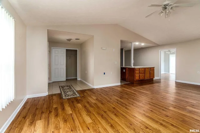 a view of a room with wooden floor and a sink