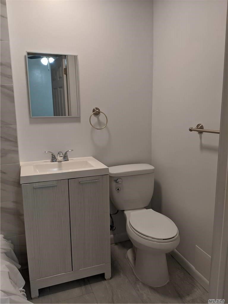 a white toilet sitting next to a bathroom sink