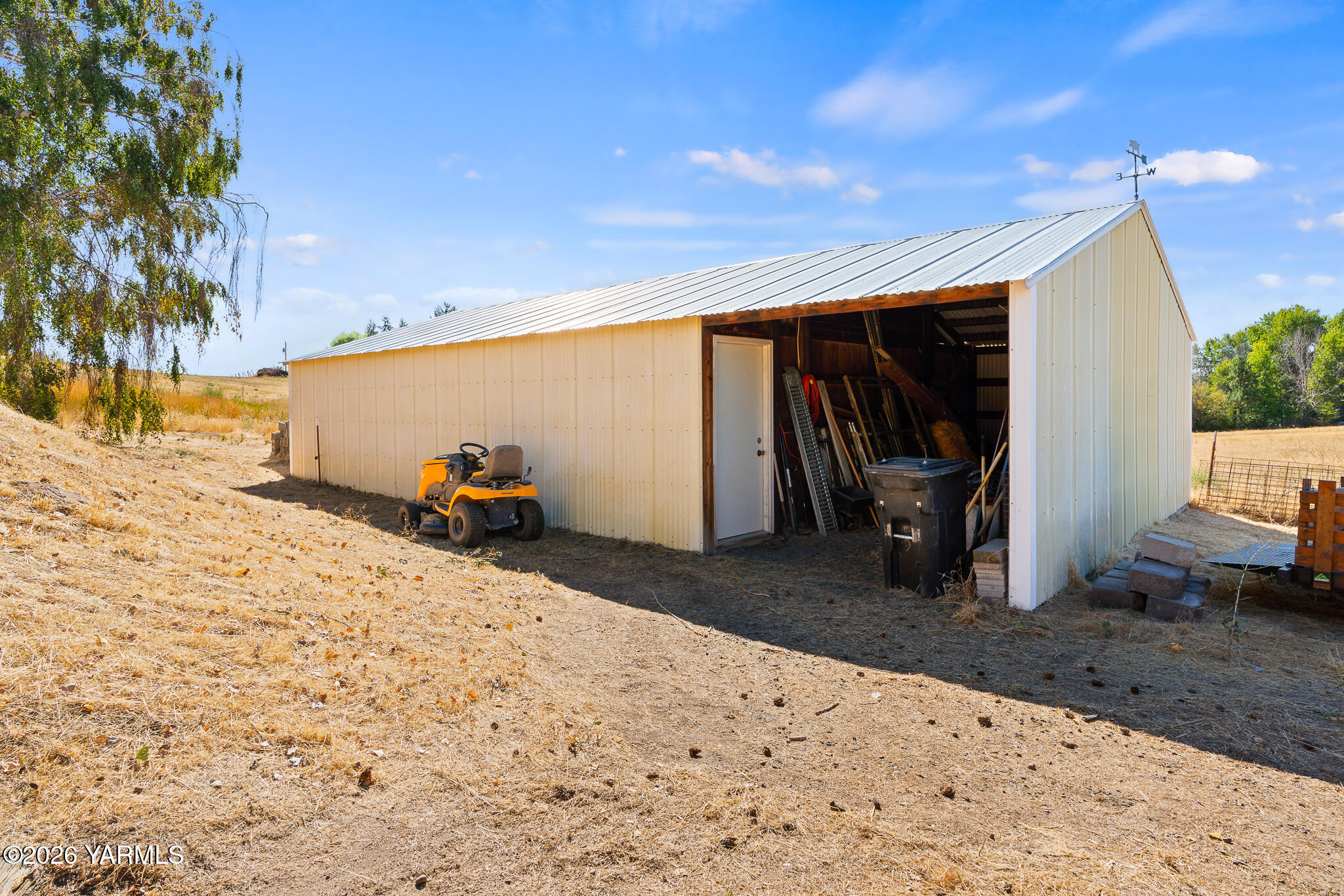 13619 Summitview Ext Road Yakima, WA 98908 - Photo 51 of 56 a view of a backyard space of a house with wooden roof and glass windows