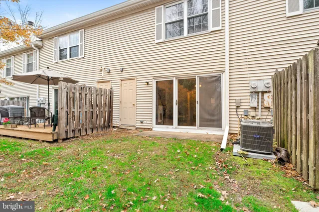 a view of a backyard with a small cabin and wooden fence