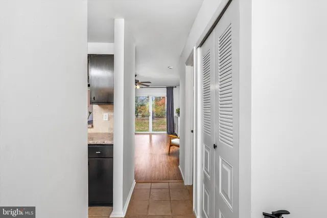 hallway with view of bathroom and utility room