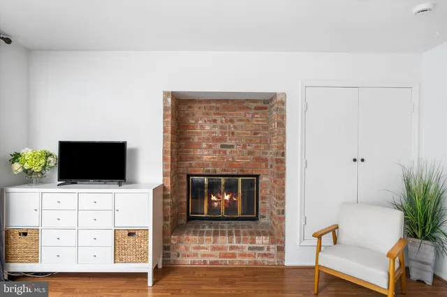 a living room with flat screen tv and a fireplace