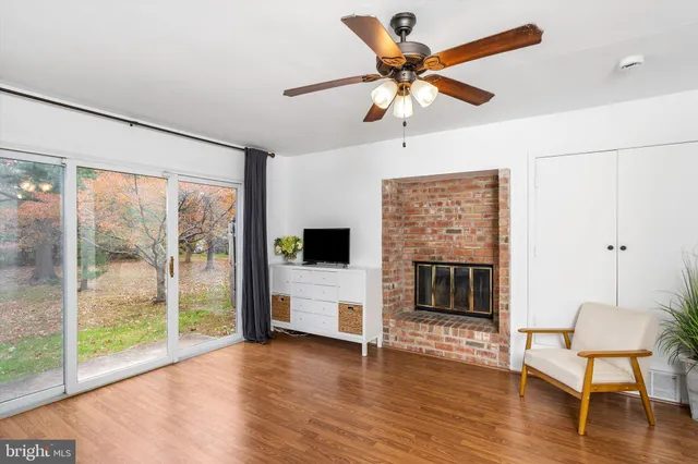 a view of a livingroom with furniture wooden floor window and a fireplace