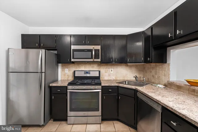 a kitchen with a sink stove and refrigerator
