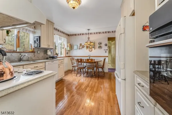 a dining room with furniture and a kitchen view