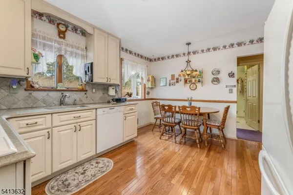 a view of dining table chairs and wooden floor