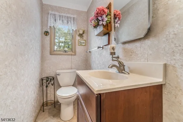 a bathroom with a sink toilet and a mirror