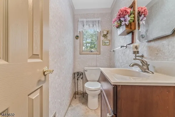 a bathroom with a sink toilet and a mirror