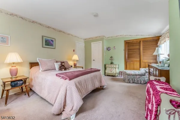 a bedroom with bed and a couch