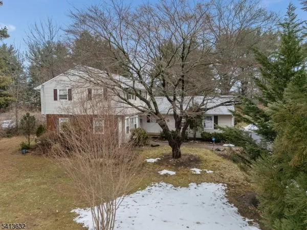 a view of a house with a snow in the yard
