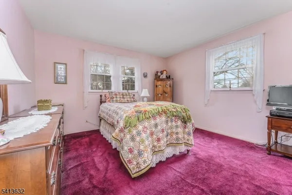 a bedroom with a bed and a desk
