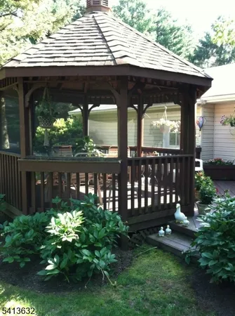 a view of a chairs and table in the back yard